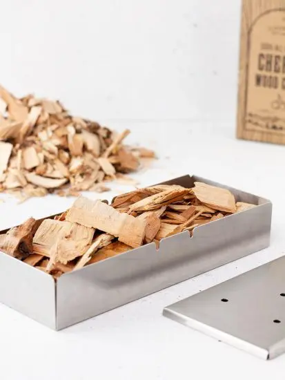 Smoking wood chips in metal containers