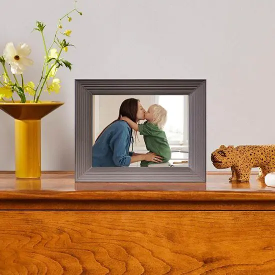 Aura digital photo frame sitting on top of dresser