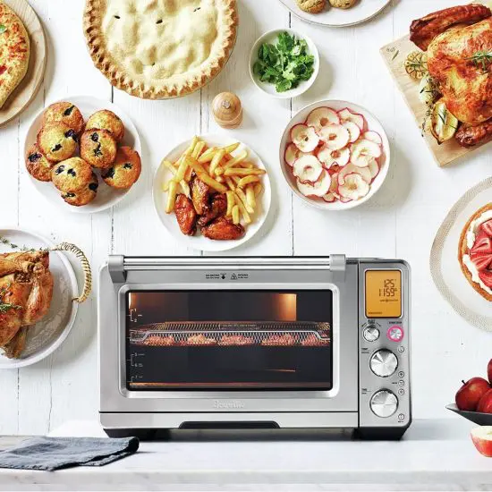 Smart air fryer by Breville surrounded by food