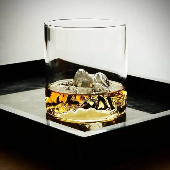 Denali mountain whiskey glass on black serving tray
