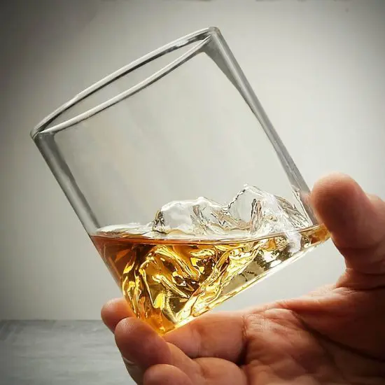 Man holding Denali Mountain whiskey glass