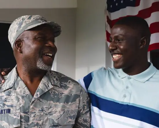 Military retiree dad and son smiling