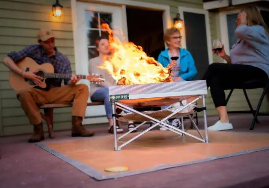 Family using pop up fire pit on outdoor patio