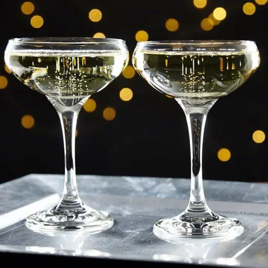 Champagne inside two cocktail coupe glasses