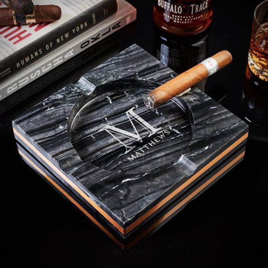 Custom black marble cigar ashtray with cigar on it