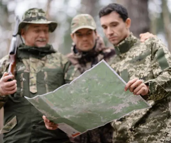 Group of men surveying a map