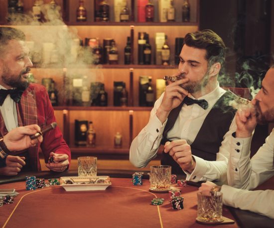 Group of gentlemen smoking and playing poker