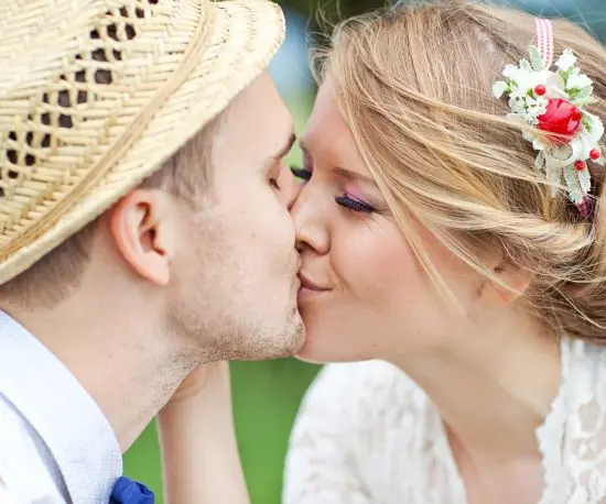 Close up shot of a newlywed couple kissing
