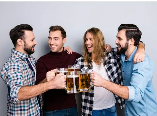Happy group of guy friends holding beer mugs