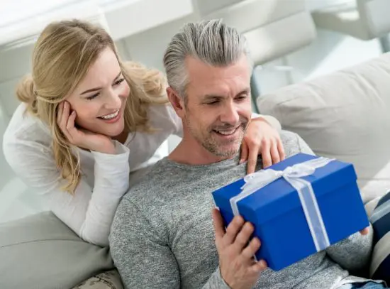 Candid shot of happy couple looking at a gift