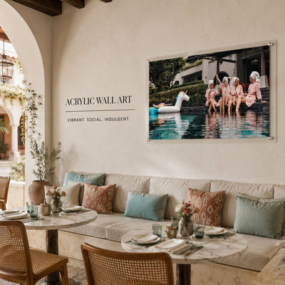 Poolside acrylic wall art with women in pink robes and unicorn float