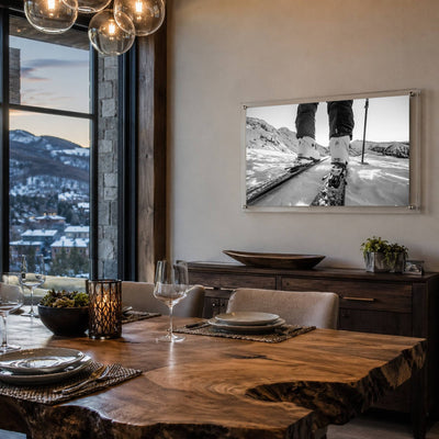 Black and white mountain road wall art displayed in a city-view dining room