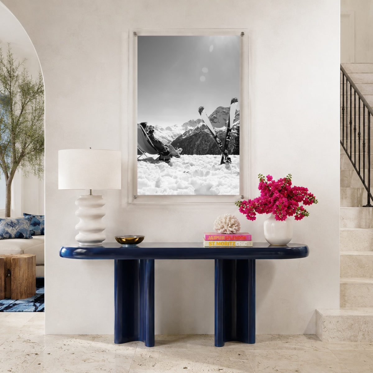 Black and white ski wall art on a modern navy console table area