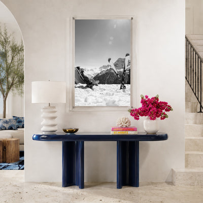 Black and white ski wall art on a modern navy console table area