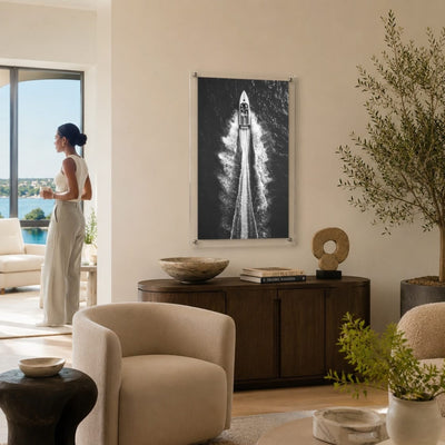 Exit By Sea wall art in a modern coastal living room setting with woman standing