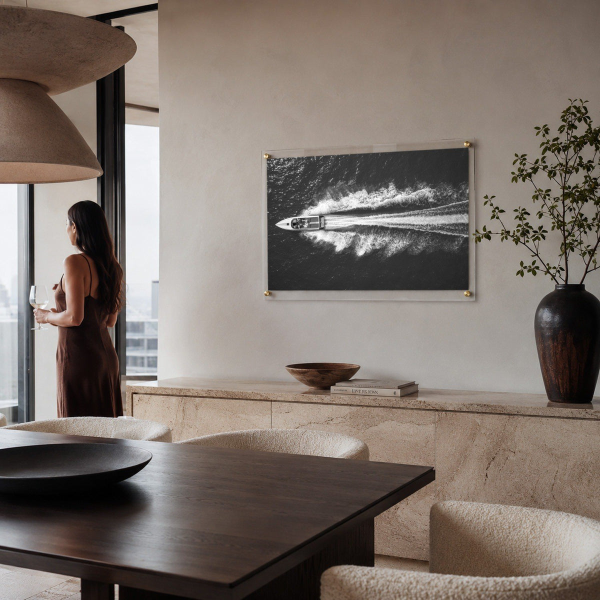 Exit By Sea wall art in a modern dining room with a woman aside looking afar