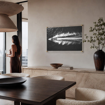 Exit By Sea wall art in a modern dining room with a woman aside looking afar