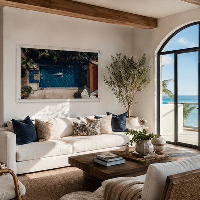 Lap of Luxury wall art displayed above a sofa in a living room with coastal ocean view