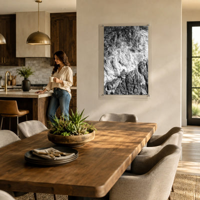 Foam and Fire wall art in a modern dining room with a woman