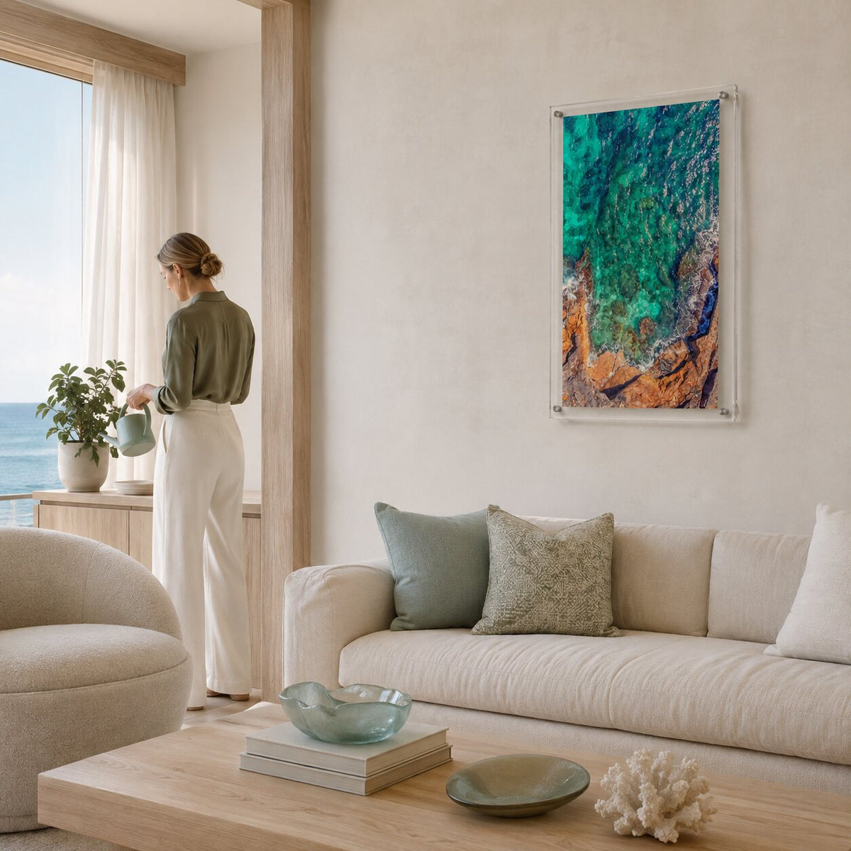 Sea Glass Shore wall art in a bright modern living room with woman aside