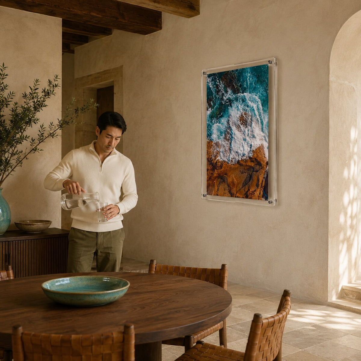 Man standing in dining room with colorful ocean acrylic wall art