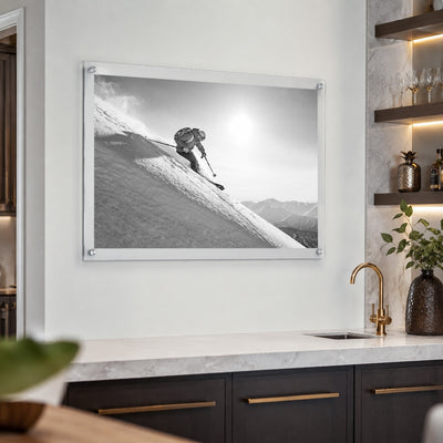 Steep Thrills acrylic wall art displayed above a white kitchen wet bar