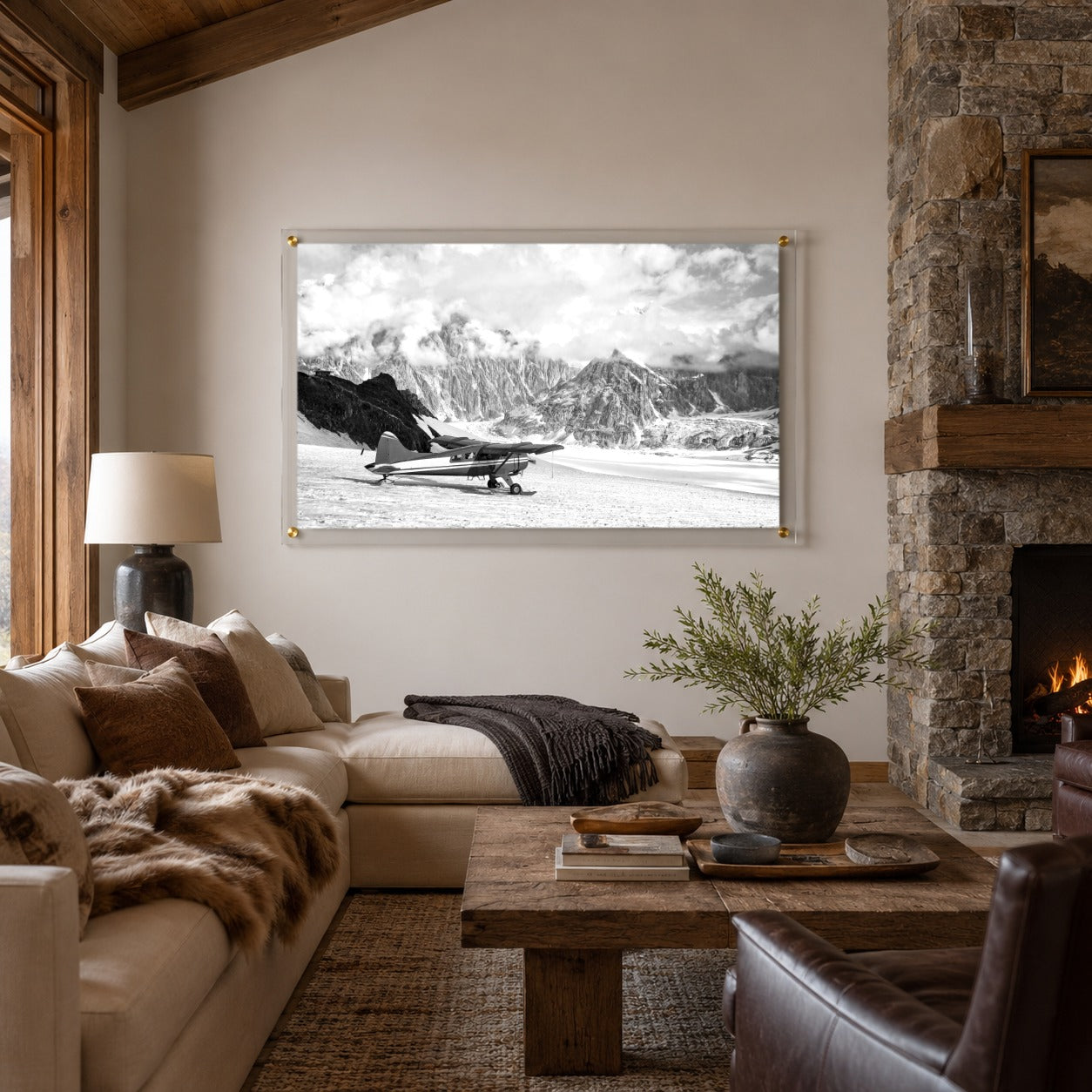 Where Adventure Begins acrylic wall art above a cozy lodge stone fireplace