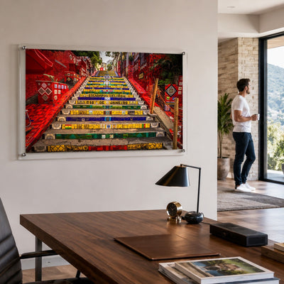 Stairway to Rio acrylic wall art displayed above a modern wood office desk with man standing aside