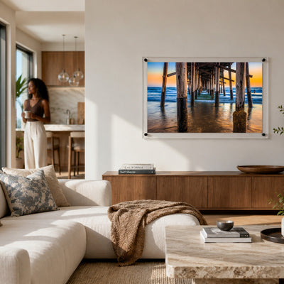 Pier Pressure acrylic wall art displayed in a modern living room interior with woman standing afar