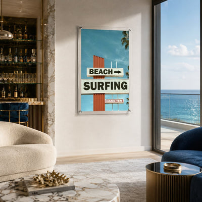 Next Stop Surf acrylic wall art displayed beside a coastal ocean view scene