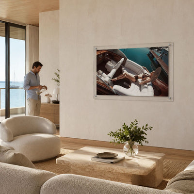 Sea La Vie acrylic wall art in a bright modern living room scene with a man standing aside