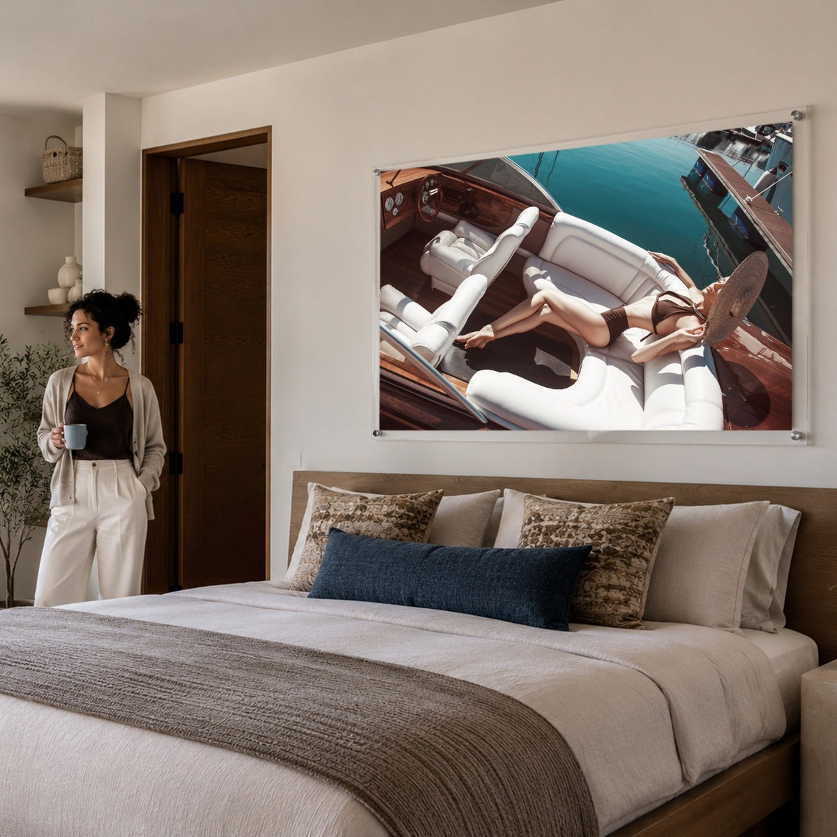 Sea La Vie acrylic wall art displayed above a modern bedroom bed frame with woman standing aside