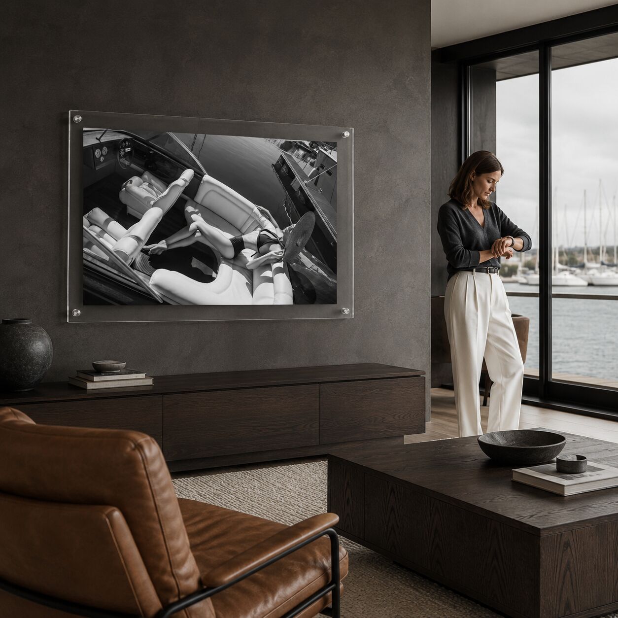 Sea La Vie BW acrylic wall art in a dark living room next to one woman