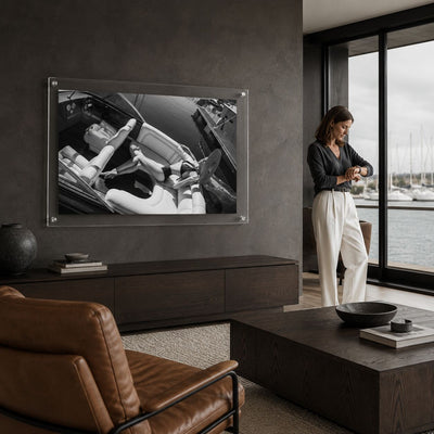 Sea La Vie BW acrylic wall art in a dark living room next to one woman