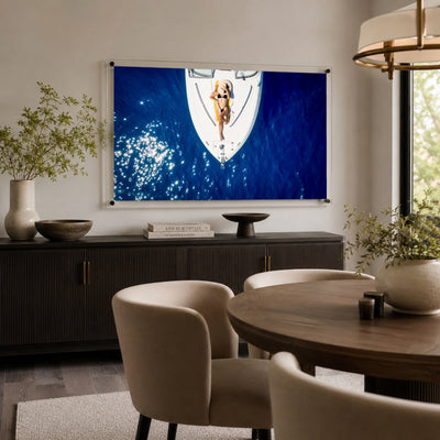 Sun Deck Society wall art hanging over a modern dining room sideboard