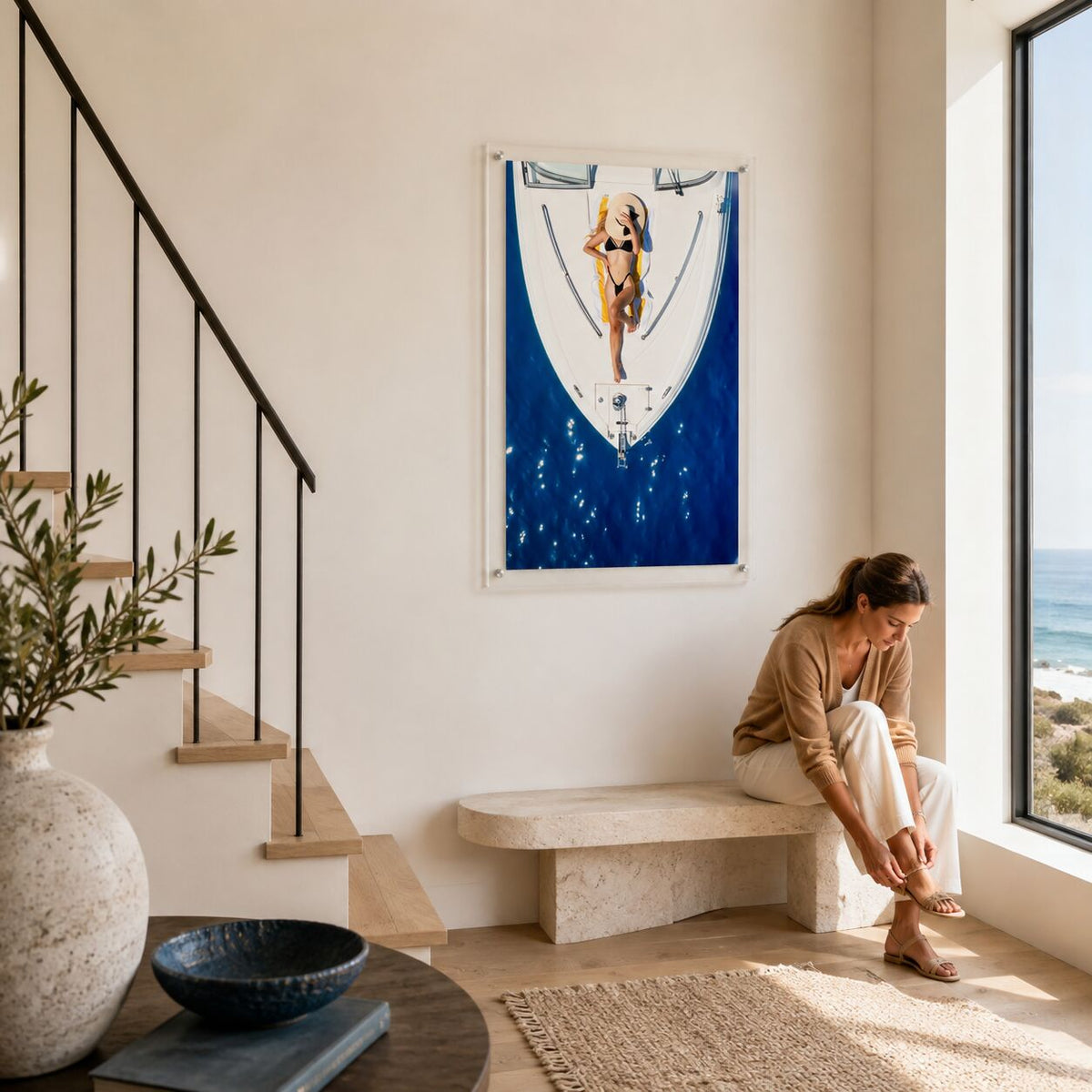 Sun Deck Society wall art above a bench where a woman sits near the stairs