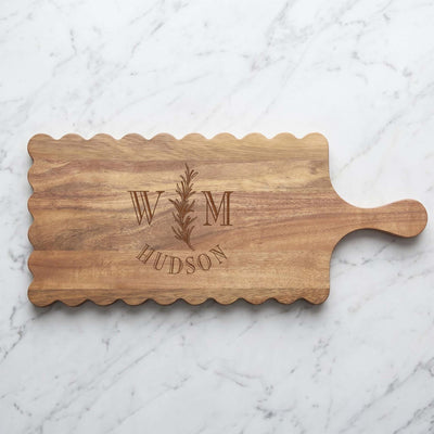 Custom acacia serving board with a decorative scalloped border 