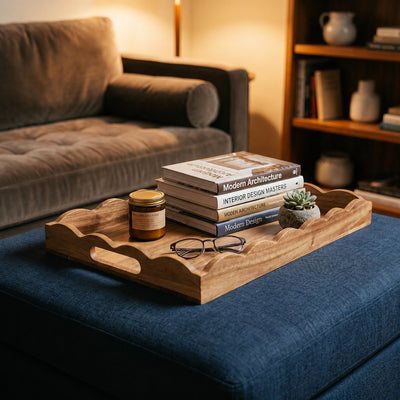 Acacia wood scalloped serving tray styled on a blue ottoman