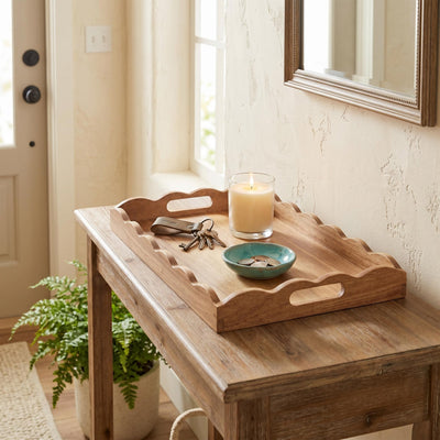 Acacia scalloped wood serving tray styled on an entryway table