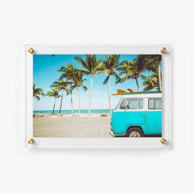 Beach travel artwork with a van parked along a sunny shoreline