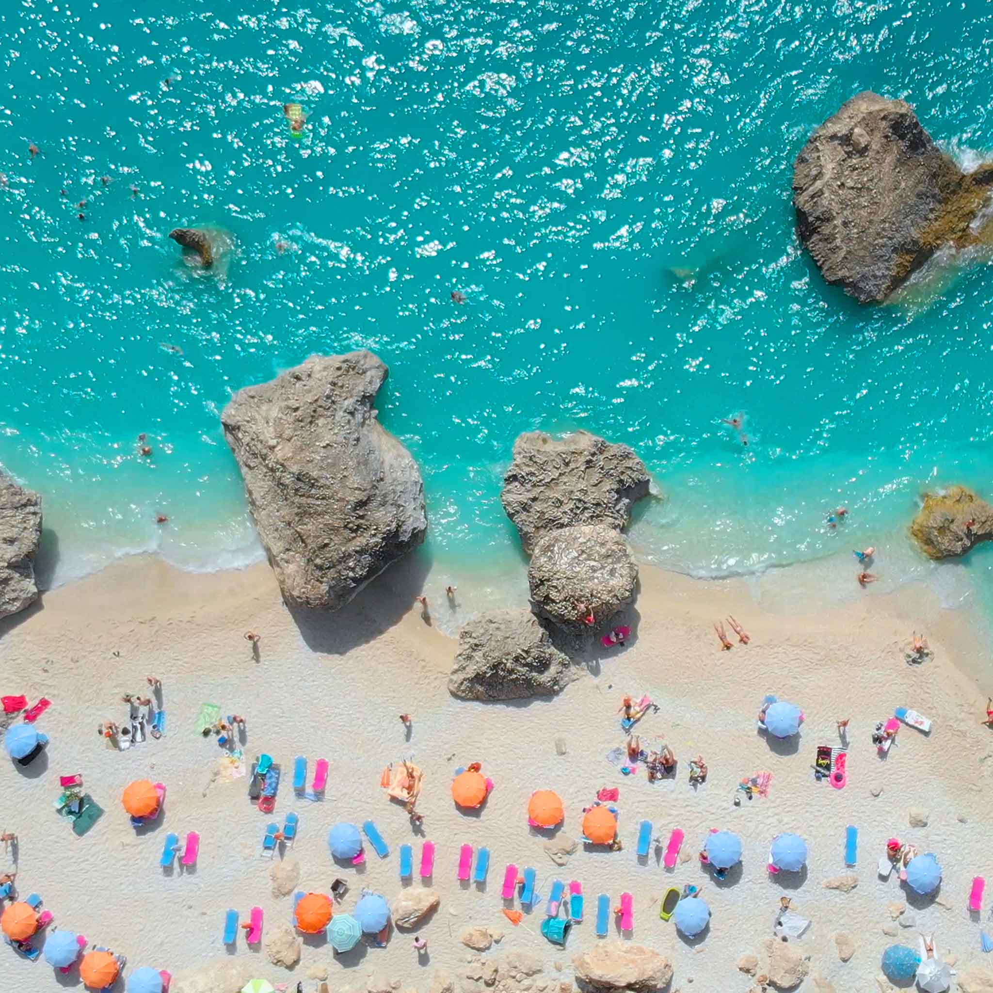 Clear blue lagoon and sandy beach viewed from above 