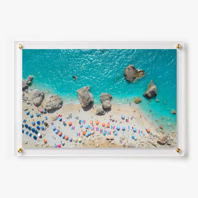 Aerial beach acrylic wall art featuring turquoise water, rocks, umbrellas, and sunbathers