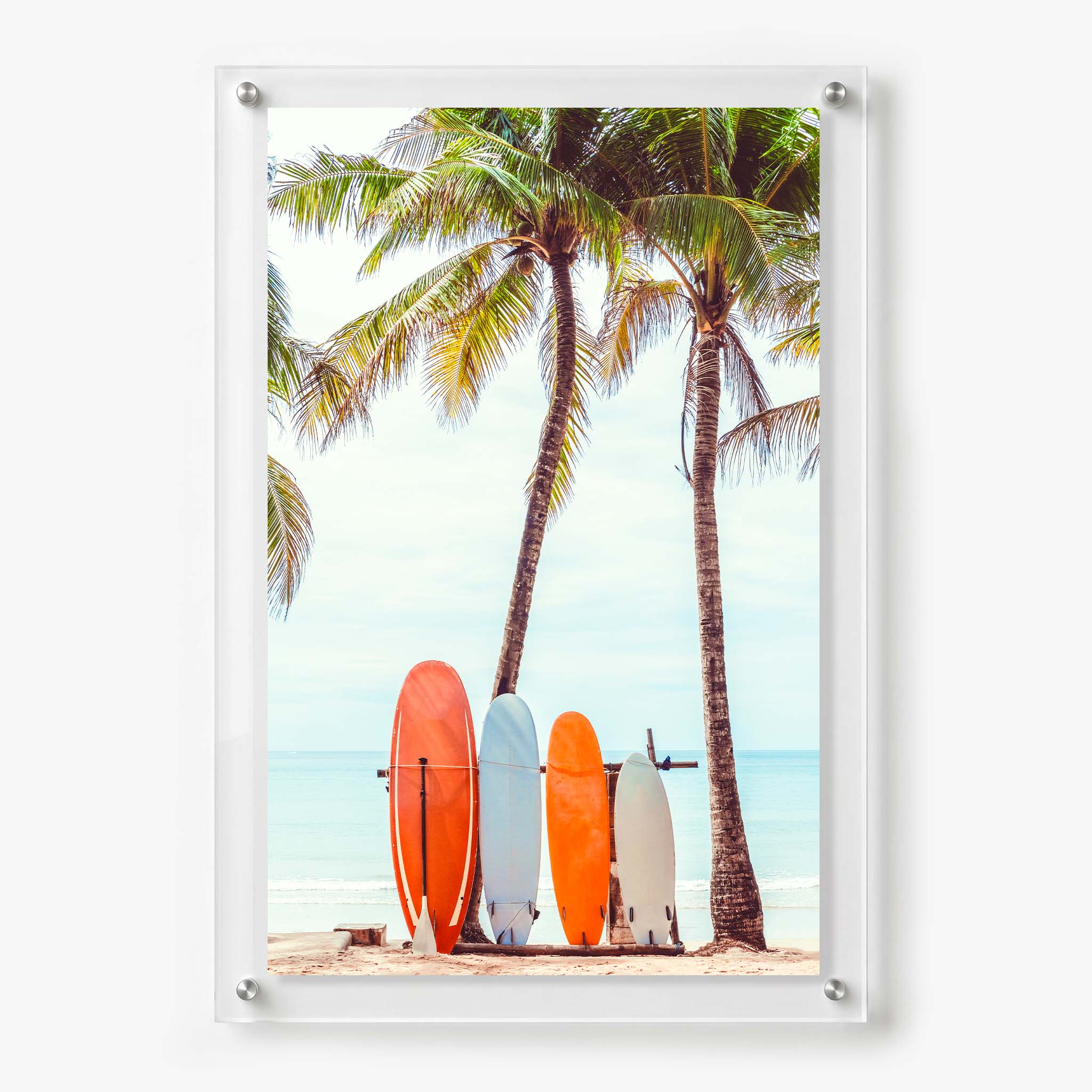 Acrylic wall art featuring colorful surfboards standing beneath tall palm trees on a tropical beach