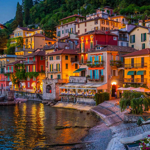 Evening view of illuminated waterfront homes along Lake Como