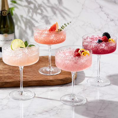 coupe cocktail glasses with colorful fruity drinks