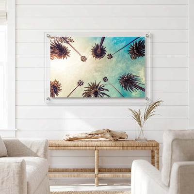 Tropical wall decor with tall palm trees displayed in a bright living room