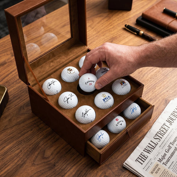 Person placing a collectible golf ball into the display case 