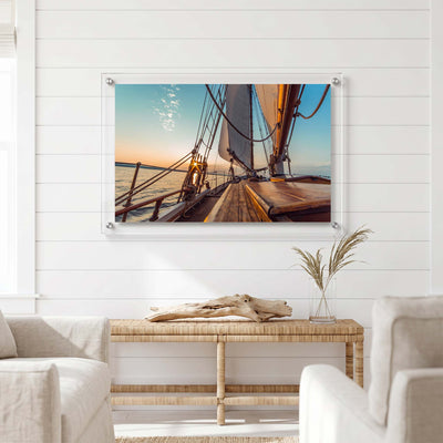 Nautical acrylic wall art showing a wooden sailing yacht displayed in a bright room
