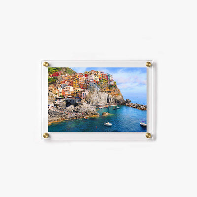 Vibrant coastal landscape featuring a historic Italian village beside the sparkling sea