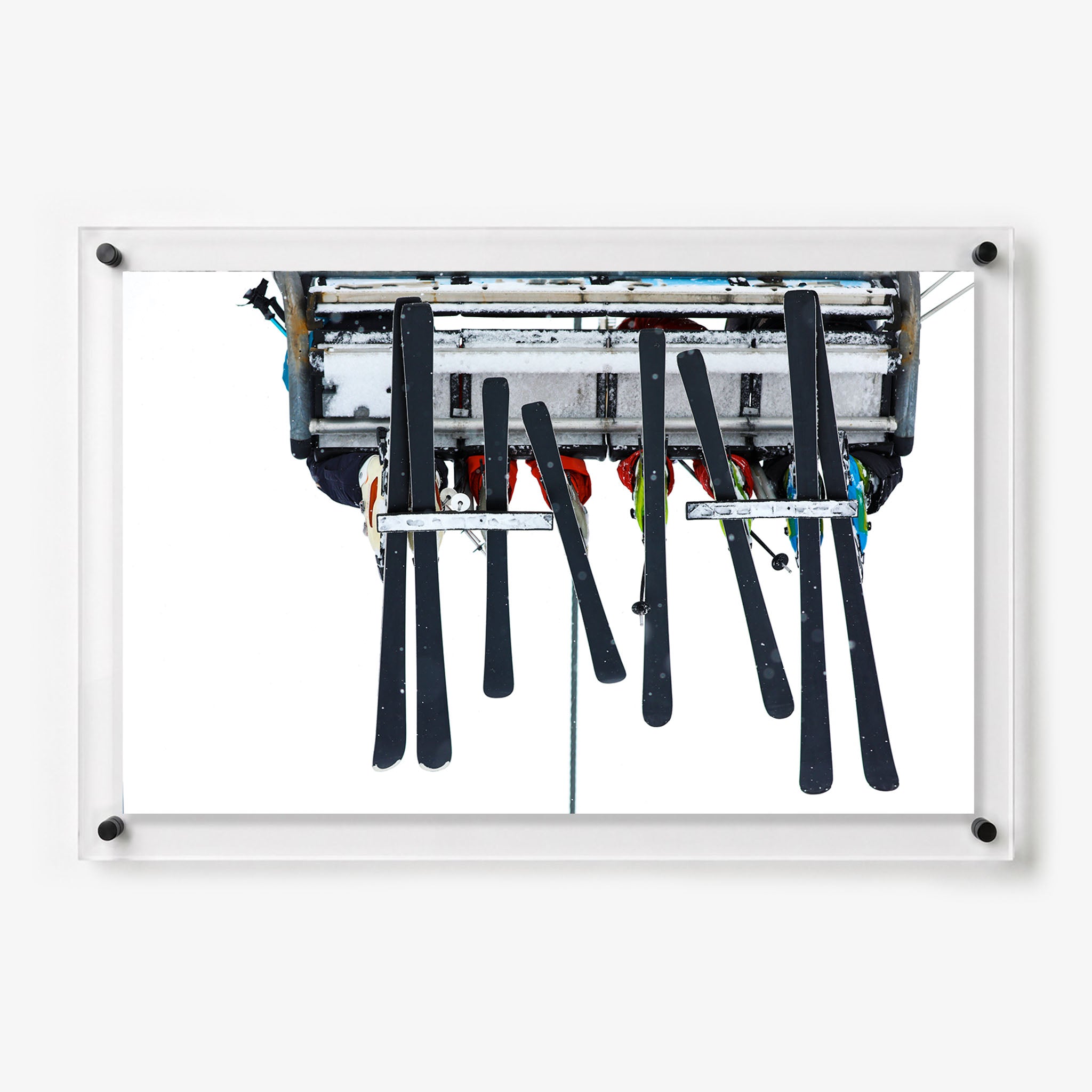 Acrylic wall art featuring skiers riding a chairlift 